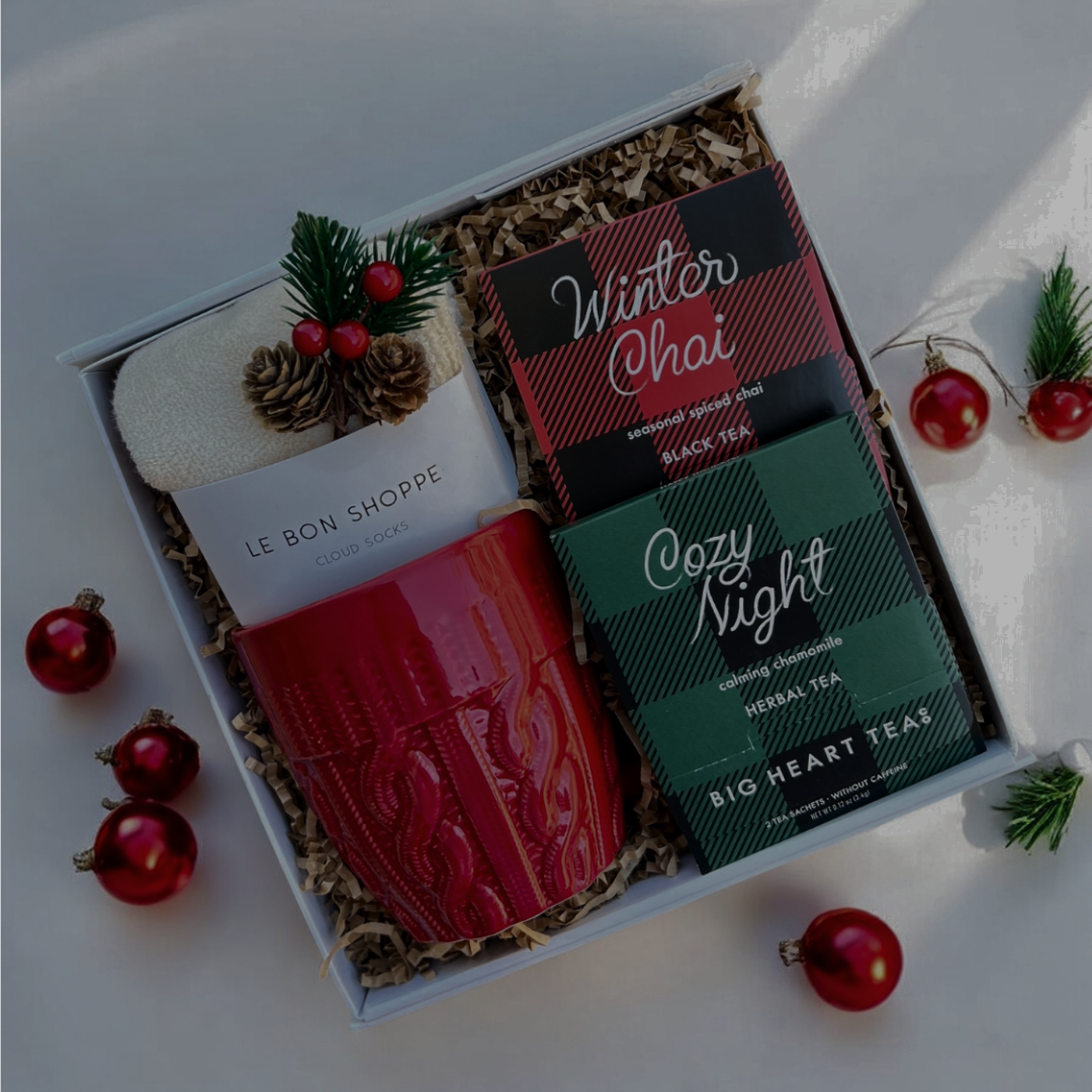 Two tea bags in a decorative box with Christmas decorations on a white background